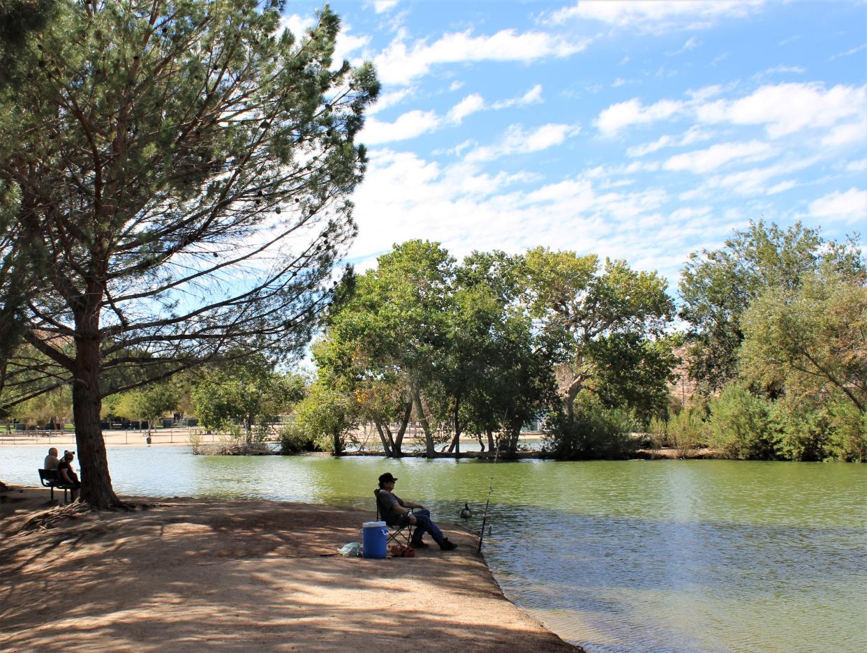 Folks just relaxing shoreline  at Hesperia Lake Park.