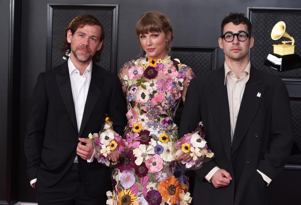 Aaron Dessner (left) co-wrote and co-produced "Folklore" and "Evermore" with Taylor Swift (middle), winning a Grammy for Album Of The Year on "Folklore."