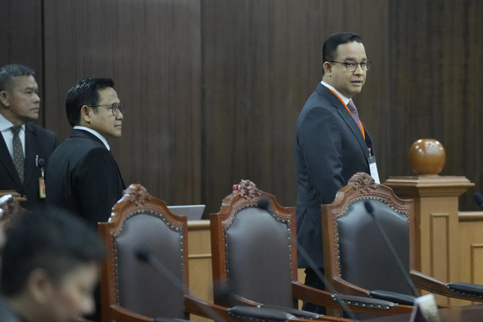 Losing presidential candidate Anies Baswedan, right, and his running mate Muhaimin Iskandar arrive for the first hearing of their legal challenge to the Feb. 14 presidential election alleging widespread fraud, at the Constitutional Court in Jakarta, Indonesia, Wednesday, March 27, 2024. Defense Minister Prabowo Subianto, who chose the son of the popular outgoing President Joko Widodo as his running mate, won the election by 58.6% of the votes, according to final results released by the Election Commission. (AP Photo/Dita Alangkara)