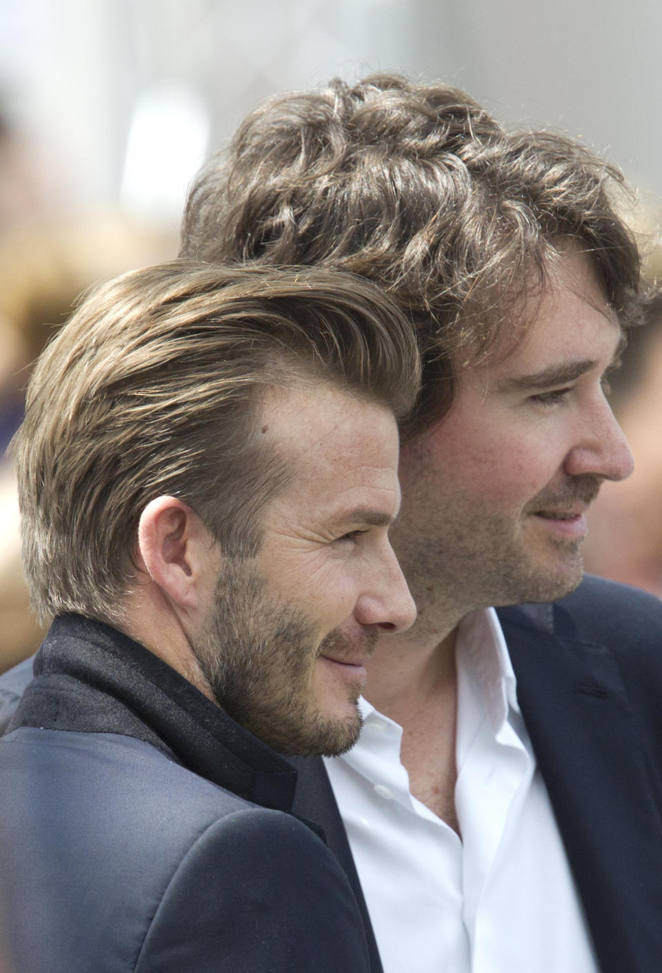 Former British soccer star David Beckham, left, and Antoine Arnault, a member of French luxury brand LVMH board of chairman, pose for photographers during Vuitton's Spring-Summer 2014 men's collection presented Thursday, June 27, 2013 in Paris. (AP Photo/Jacques Brinon)