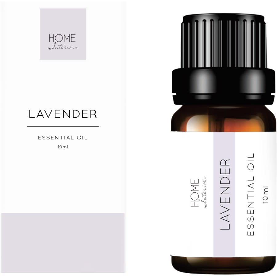 A dark small bottle of Home Interiors Lavender Essential Oil, $5 beside its box, which both have lavender and white labels with black writing.