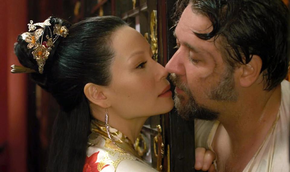 This image released by Universal Pictures shows Lucy Liu, left, and Russell Crowe in a scene from "The Man With the Iron Fists." (AP Photo/Universal Pictures)