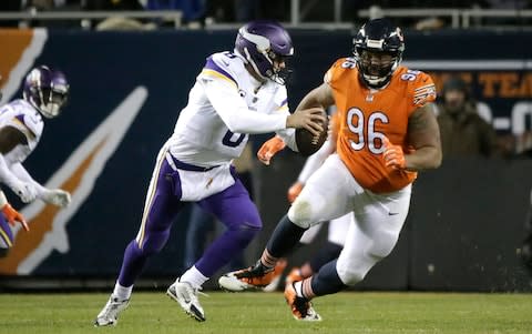 Chicago Bears defensive end Akiem Hicks (96) pursuing Minnesota Vikings quarterback Kirk Cousins (8) during the second half of an NFL football game in Chicago. The Vikings need to beat division champion Chicago this weekend to ensure their place in the playoffs, putting the pressure on Cousins to prove his worth as the franchise quarterback - Credit: AP