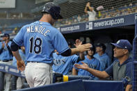 Tampa Bay Rays' Joey Wendle (18) celebrates with manager Kevin Cash after scoring on an RBI single by Kevin Kiermaier off Baltimore Orioles pitcher Jorge Lopez during the first inning of a baseball game Saturday, June 12, 2021, in St. Petersburg, Fla. (AP Photo/Chris O'Meara)