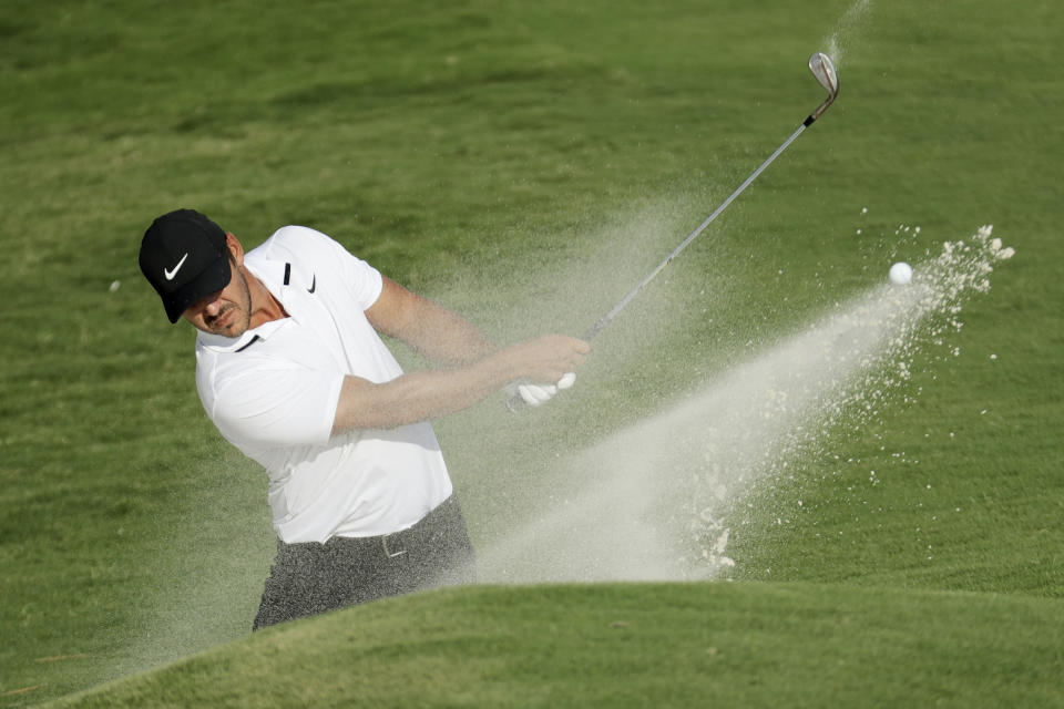 Brooks Koepka hits from the bunker on the 18th hole during the final round of the World Golf Championship-FedEx St. Jude Invitational Sunday, Aug. 2, 2020, in Memphis, Tenn. (AP Photo/Mark Humphrey)