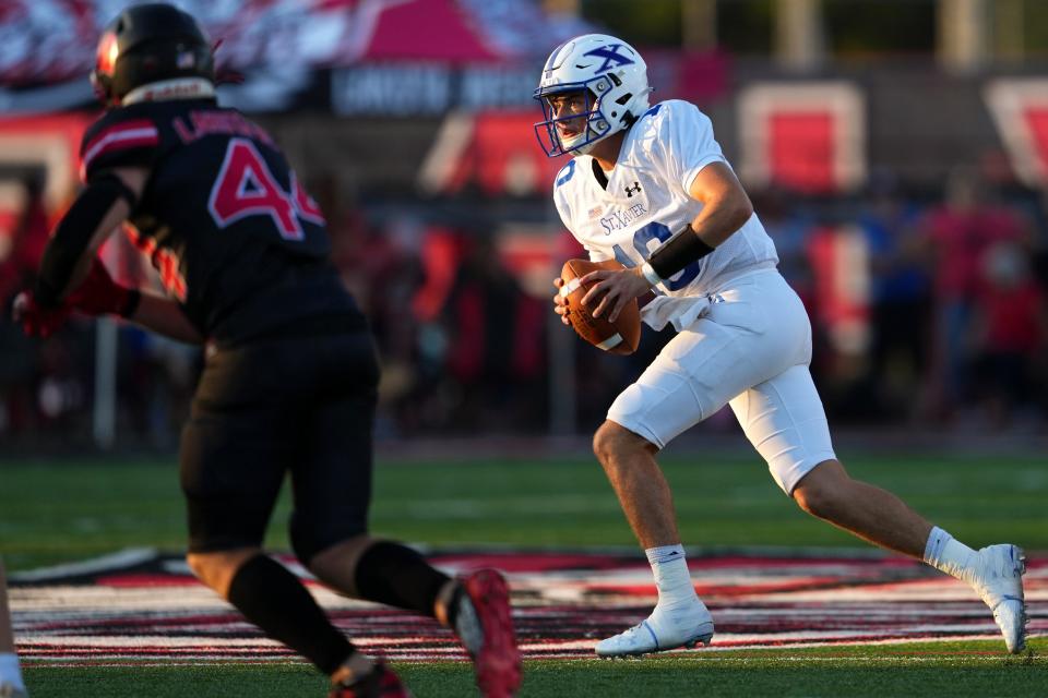 St. Xavier quarterback Jack O'Malley (10) runs out of the pocket in the second quarter during a high school football game against the Lakota West Firebirds, Friday, Aug. 19, 2022, at Firebirds Stadium in West Chester Township, Ohio.