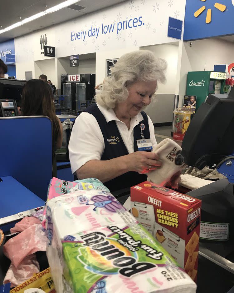 Walmart cashier helping customer in checkout