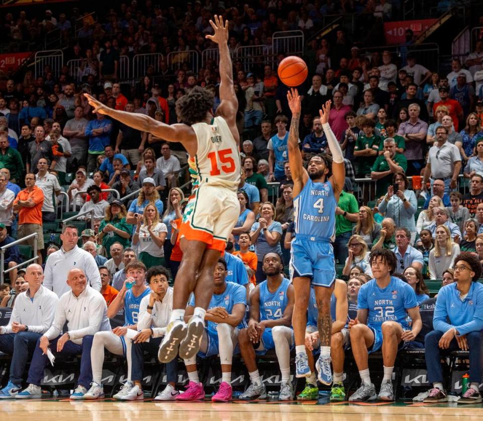 North Carolina’s R.J. Davis (4) launches a three-point shot over Miami’s Norchad Omier (15) in the second half on Saturday, February 10, 2024 at the Watsco Center in Coral Gables, Florida. Davis led all scores with 25 points in the Tar Heels’ 75-72 victory. Robert Willett/rwillett@newsobserver.com
