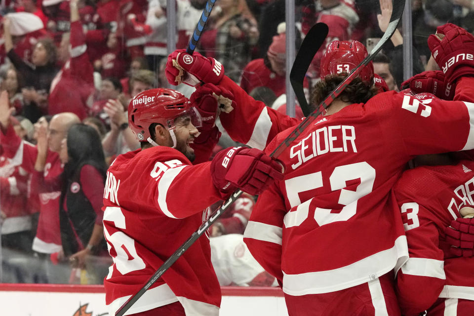 Detroit Red Wings defenseman Jake Walman (96) celebrates with teammates after a goal by left wing Lucas Raymond during the second period of an NHL hockey game, Saturday, Oct. 14, 2023, in Detroit. (AP Photo/Carlos Osorio)