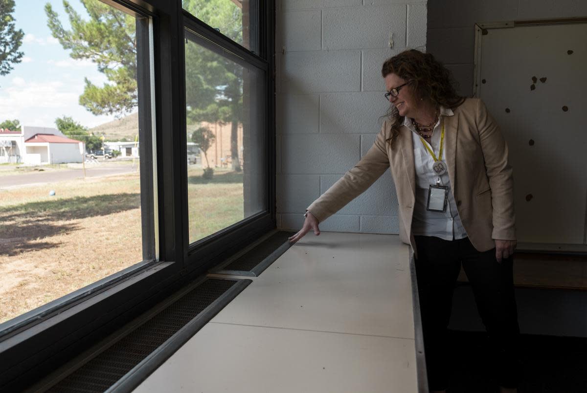 Alpine ISD Superintendent Michelle Rinehart points to heaters that need to be upgraded inside a classroom at Alpine Elementary School.