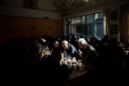 People eat at a soup kitchen run by the Orthodox church in Athens, Greece, February 15, 2017. REUTERS/Alkis Konstantinidis