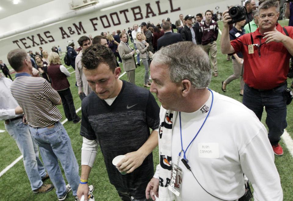 Texas A&M quarterback Johnny Manziel leaves the McFerrin Athletic Center after performing drills at pro day for NFL football representatives in College Station, Texas, Thursday, March 27, 2014. (AP Photo/Patric Schneider)