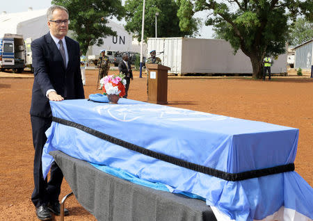 Koen Davidse, head of MINUSMA, pays his respects in front of one of the three coffins of the United Nations soldiers from Bangladesh, who were killed by an explosive device in northern Mali on Sunday, at the MINUSMA base in Bamako, Mali September 27, 2017. REUTERS/Moustapha Diallo