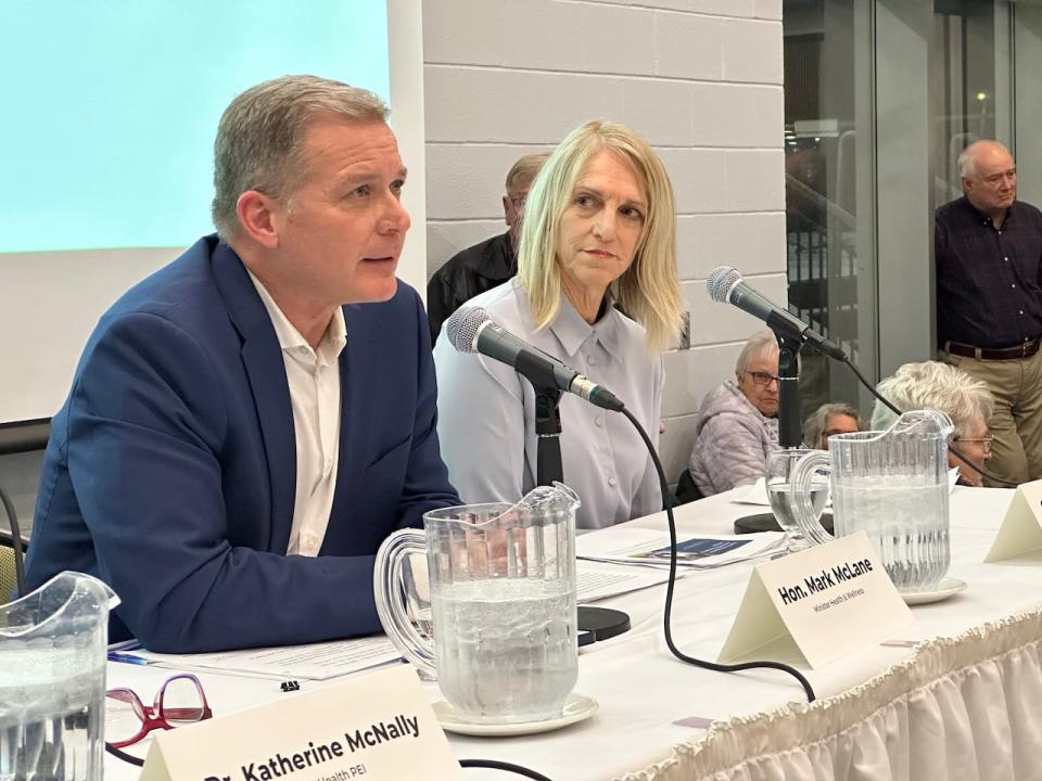 Health Minister Mark McLane speaks to a packed town hall meeting in Summerside as acting Health P.E.I. CEO Corinne Rowswell looks on. 