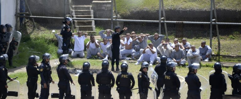 Riot police control inmates at a juvenile detention center in San Jose Pinula, east of Guatemala City, following a deadly prison riot