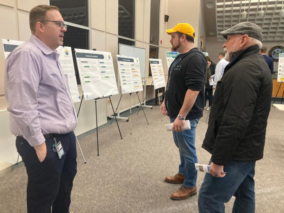 Millcreek Township planning and development Director Matt Waldinger, left, talks with Sam Comfort, center, and Gerry Servidio during a public information session on Presque Isle Gateway District plans on Tuesday. Comfort is a candidate for the Democratic nomination for Millcreek supervisor in the May 16 municipal primary.