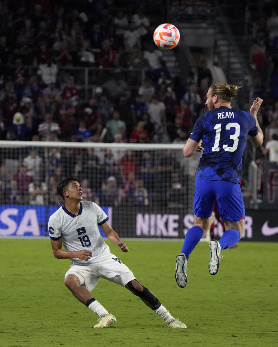 United States defender Tim Ream (13) heads the ball over El Salvador forward Kevin Reyes (19) during the first half of a CONCACAF Nations League soccer match Monday, March 27, 2023, in Orlando, Fla. (AP Photo/John Raoux)
