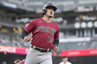 Arizona Diamondbacks' Josh Rojas scores a run on a ball hit by Ketel Marte and a fielding error by San Francisco Giants' LaMonte Wade during the first inning of a baseball game Wednesday, June 16, 2021, in San Francisco. (AP Photo/Tony Avelar)