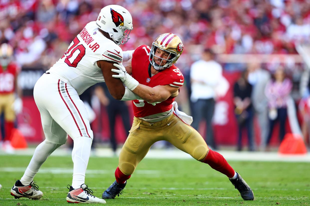 San Francisco 49ers defensive end Nick Bosa (97) rushes against Arizona Cardinals offensive tackle Paris Johnson Jr. (70) during the first quarter at State Farm Stadium in Glendale on Dec. 17, 2023.