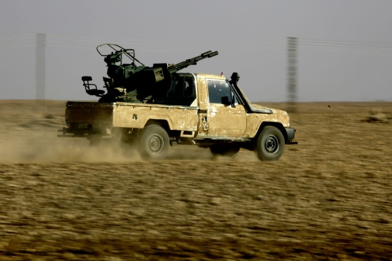 Members of the Syrian Democratic Forces, which is dominated by Kurdish fighters, drive on the outskirts of the IS group bastion of Raqa, northern Syria, in December 2016