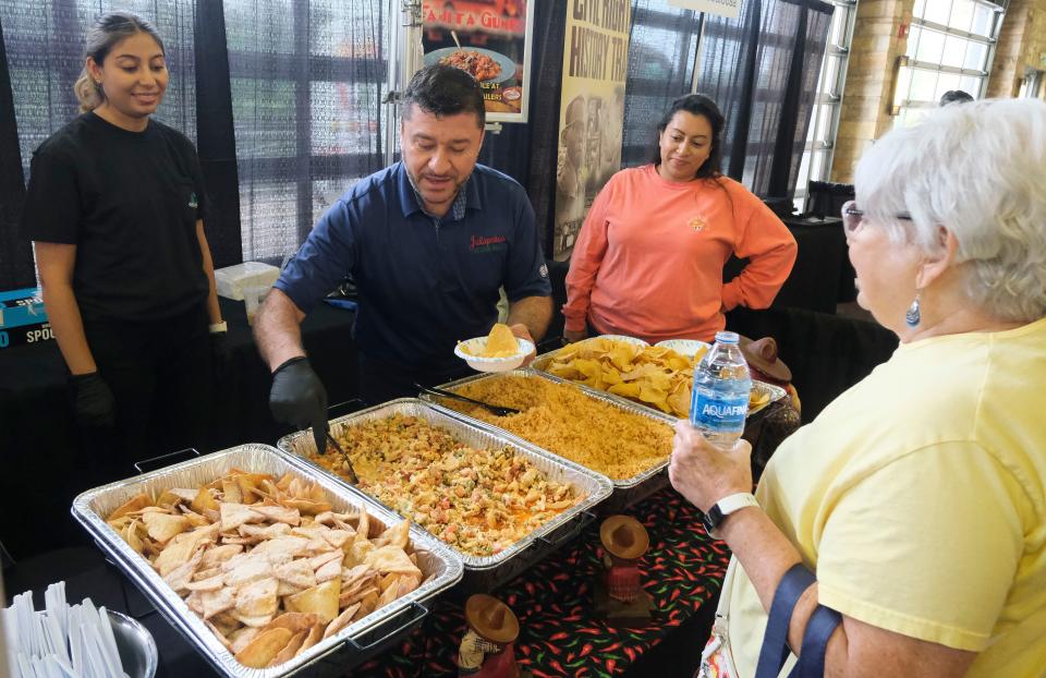 Jheovanny Gomez, owner of Jalapenos, dishes up his special gumbo to patrons during the Celebrate Local event at Tuscaloosa River Market Tuesday, June 13, 2023.