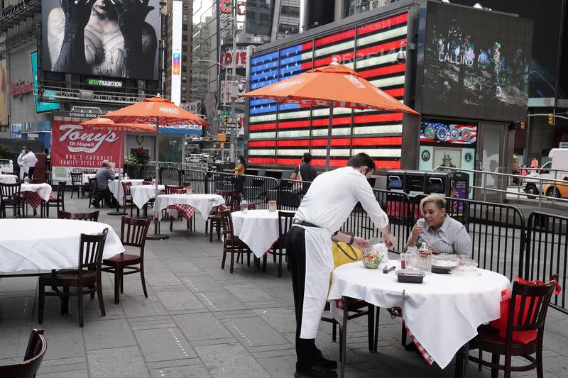 FILE PHOTO: Servers package food at a table at a pop up restaurant set up in Times Square in New York