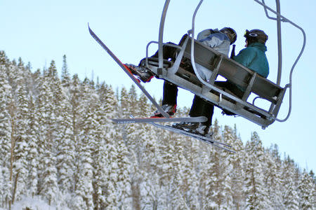 FILE PHOTO: People ride a ski lift at Taos Ski Valley, New Mexico, in December 2007. REUTERS/Christa Cameron/File Photo