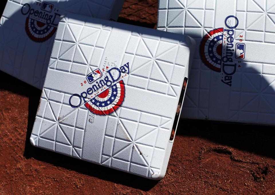 Bases sit on the warning track before an opening day baseball game between the Baltimore Orioles and the Boston Red Sox, Monday, March 31, 2014, in Baltimore. (AP Photo/Patrick Semansky)