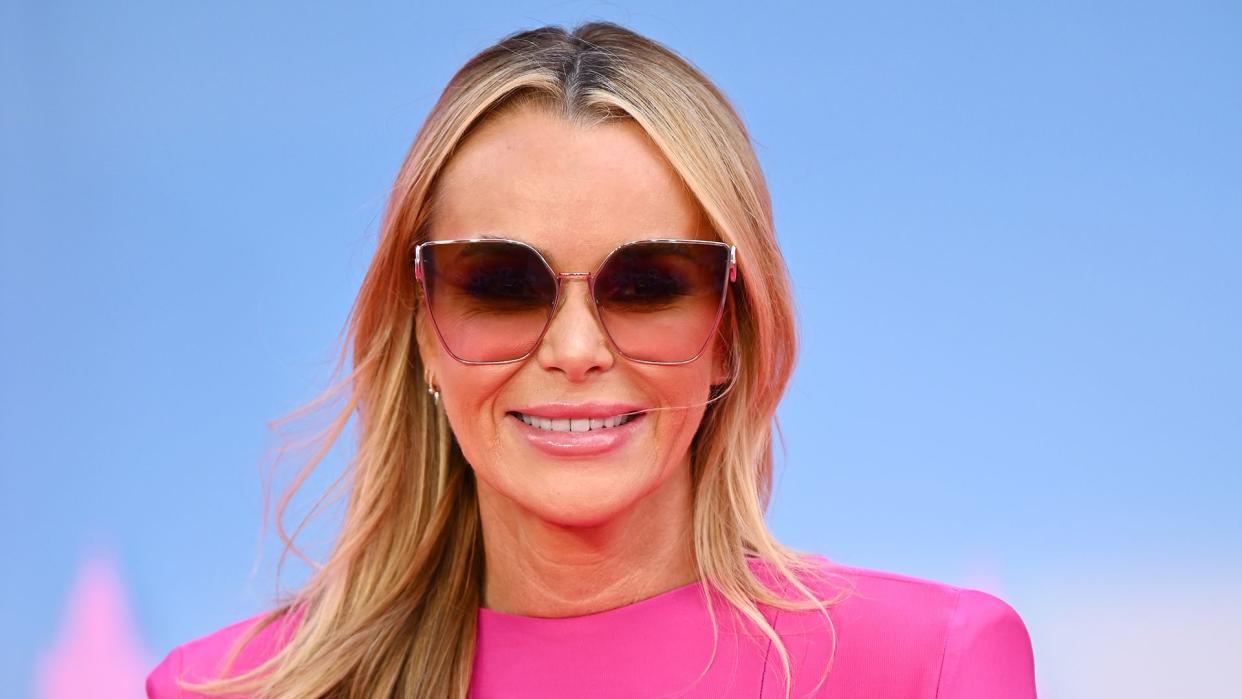 Amanda Holden wearing a pink dress and sunglasses 