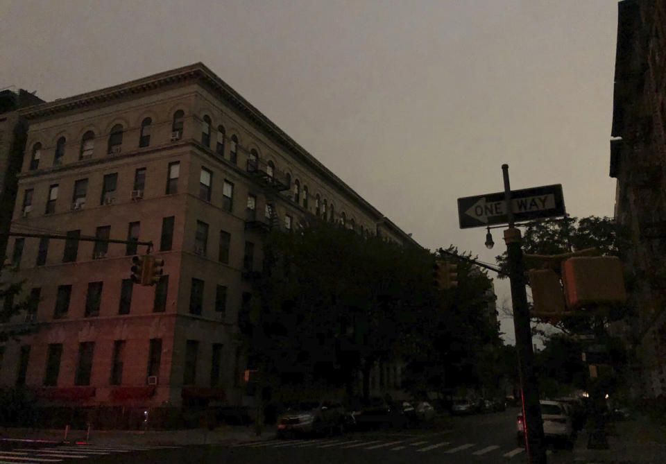 Buildings in Harlem sit dark during a power outage early, Friday, Aug. 7, 2020, in New York. A power outage cast darkness across dozens of blocks in New York City early Friday, as many people in the city were still without electricity in the aftermath of Tropical Storm Isaias. A statement from Con Edison says a transmission system problem caused three networks in Manhattan to lose their electric supply just after 5 a.m. (Tokuyuki Komiyama via AP)