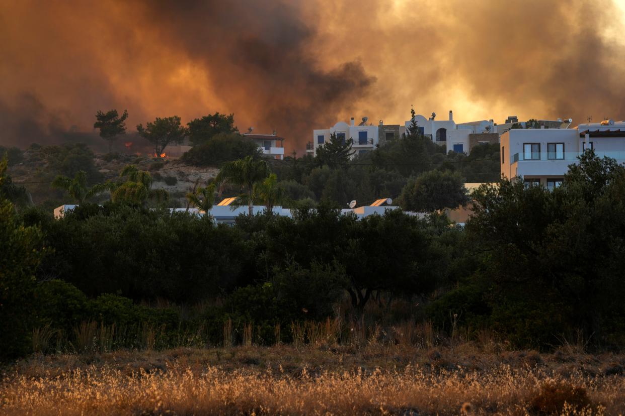 A wildfire burns in Gennadi village, on the Aegean Sea island of Rhodes in southeastern Greece on Tuesday.