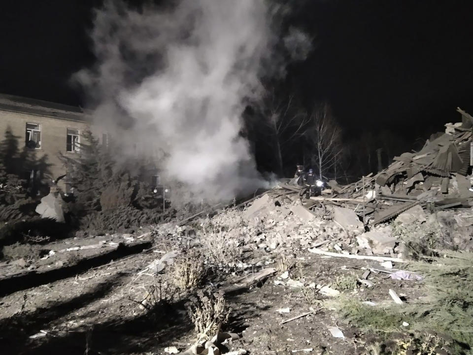 In this photo provided by the Zaporizhzhia region military administration, Ukrainian firefighters work at damaged hospital maternity ward in Vilniansk, Zaporizhzhia region, Ukraine, early Wednesday, Nov. 23, 2022. An overnight rocket attack struck a hospital maternity ward in southern Ukraine, killing a newborn baby, Ukrainian authorities said Wednesday. The baby's mother and a doctor were pulled alive from the rubble. The region's governor said the rockets were Russian. (Zaporizhzhia region military administration via AP)