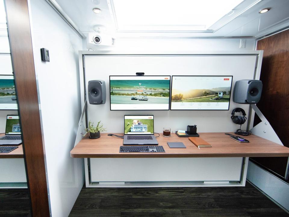 An office space with Apple products like a laptop.