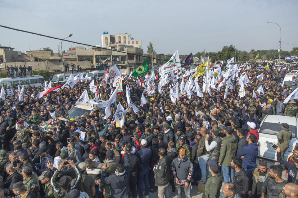 Mourners march during the funeral of Iran's top general Qassem Soleimani, 62, Abu Mahdi al-Muhandis, deputy commander of Iran-backed militias in Iraq known as the Popular Mobilization Forces and fellow militant leaders, in Baghdad, Iraq, Saturday, Jan. 4, 2020. Thousands of mourners chanting "America is the Great Satan" marched in a funeral procession Saturday through Baghdad for Iran's top general and Iraqi militant leaders, who were killed in a U.S. airstrike. (AP Photo/Nasser Nasser)