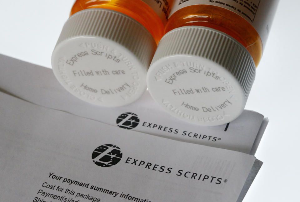 FILE - In this July 25, 2017, file photo, Express Scripts prescription medication bottles are arranged for a photo in Surfside, Fla. Health insurer Cigna will spend about $52 billion to acquire the pharmacy benefits manager Express Scripts, announced Thursday, March 8, 2018, the latest in a string of proposed buyouts and tie-ups in a rapidly shifting landscape for the health services industry. (AP Photo/Wilfredo Lee, File)