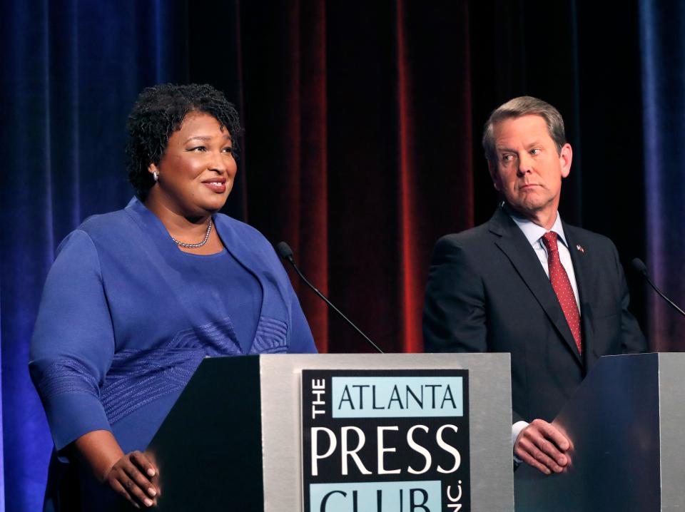 FILE - Democratic gubernatorial candidate for Georgia Stacey Abrams, left, speaks as her Republican opponent, then-Secretary of State and now Georgia Gov., Brian Kemp looks on during a debate in Atlanta.