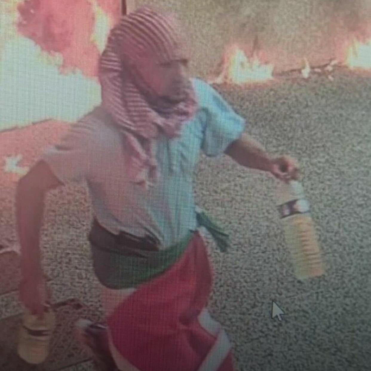 A CCTV image obtained by AFP shows a potential suspect carrying two empty bottles and a Palestinian flag draped around his waist, leaving the scene in La Grande-Motte