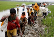 <p>Rohingya refugees walk on the muddy path after crossing the Bangladesh-Myanmar border in Teknaf, Bangladesh, Sept. 3, 2017. (Photo: Mohammad Ponir Hossain/Reuters) </p>