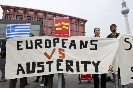 Greek activists stage a protest opposite the venue of a meeting of the Federation of German Industry (BDI) in Berlin September 27. The head of the European Commission has warned that the debt crisis posed the biggest challenge to the EU in its history as Greece made a last-gasp pitch to secure vital bailout funds