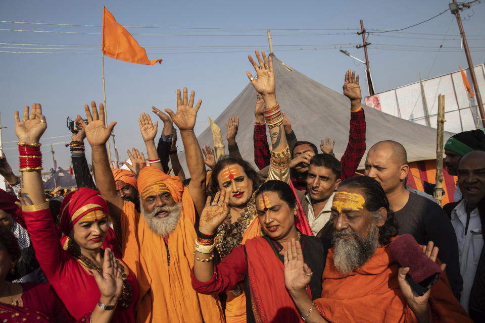 In this Jan. 14, 2019, photo, members of the monastic orders "Kinnar akhara"celebrate their official recognition with members of the "Juna akhara," one of the ancient and most orthodox monastic order, at the Kumbh Mela festival in Prayagraj, India. The "Kinnar akhara" is a monastic order formed by members of LGBTQ community and is only recognized by the "Juna akhara'," one of the 13 akharas. Mahant Suresh Das, the head of Digambar Akhara, one of the largest, said an akhara statute limits the number of orders to 13. (AP Photo/Bernat Armangue)