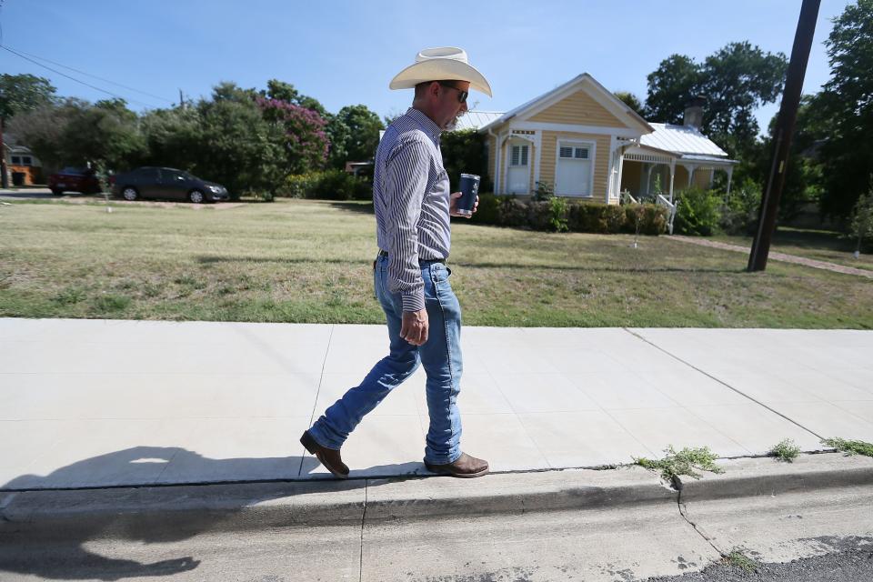 Russ Phillips, a team leader at Keller Williams Realty, walks through neighborhoods in Georgetown last week. Phillips said some of the historical houses that have been renovated are now million-dollar homes.