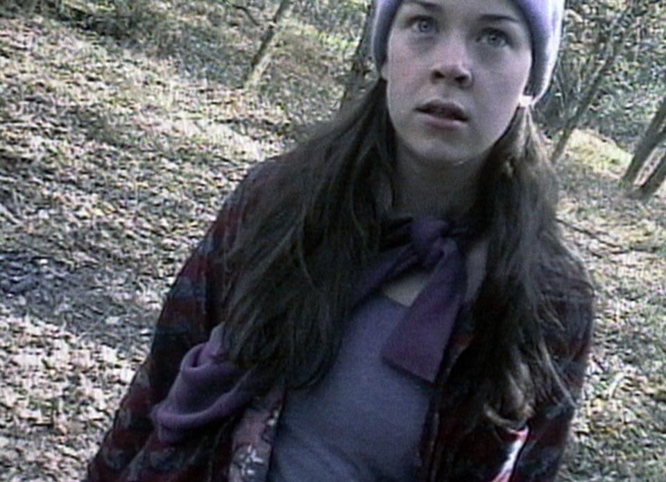 A woman standing in a forest