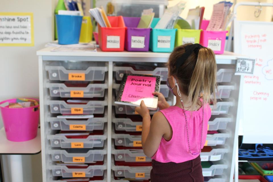 A student puts a poetry journal away in Heather Miller’s first grade class. Miller noticed most students came in lacking independence and other social skills they typically develop in kindergarten, due to distance learning last year.