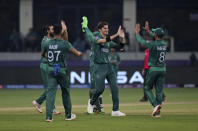 Pakistan's Shaheen Afridi, centre, celebrates with teammates after dismissing Indian cricket captain Virat Kohli during the Cricket Twenty20 World Cup match between India and Pakistan in Dubai, UAE, Sunday, Oct. 24, 2021. (AP Photo/Aijaz Rahi)