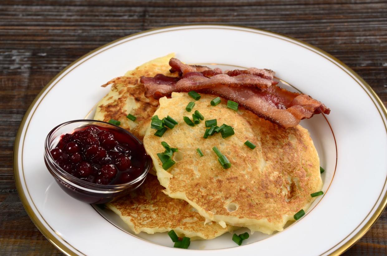 Raggmunk or Swedish potato pancakes served with fried pork and lingonberries.