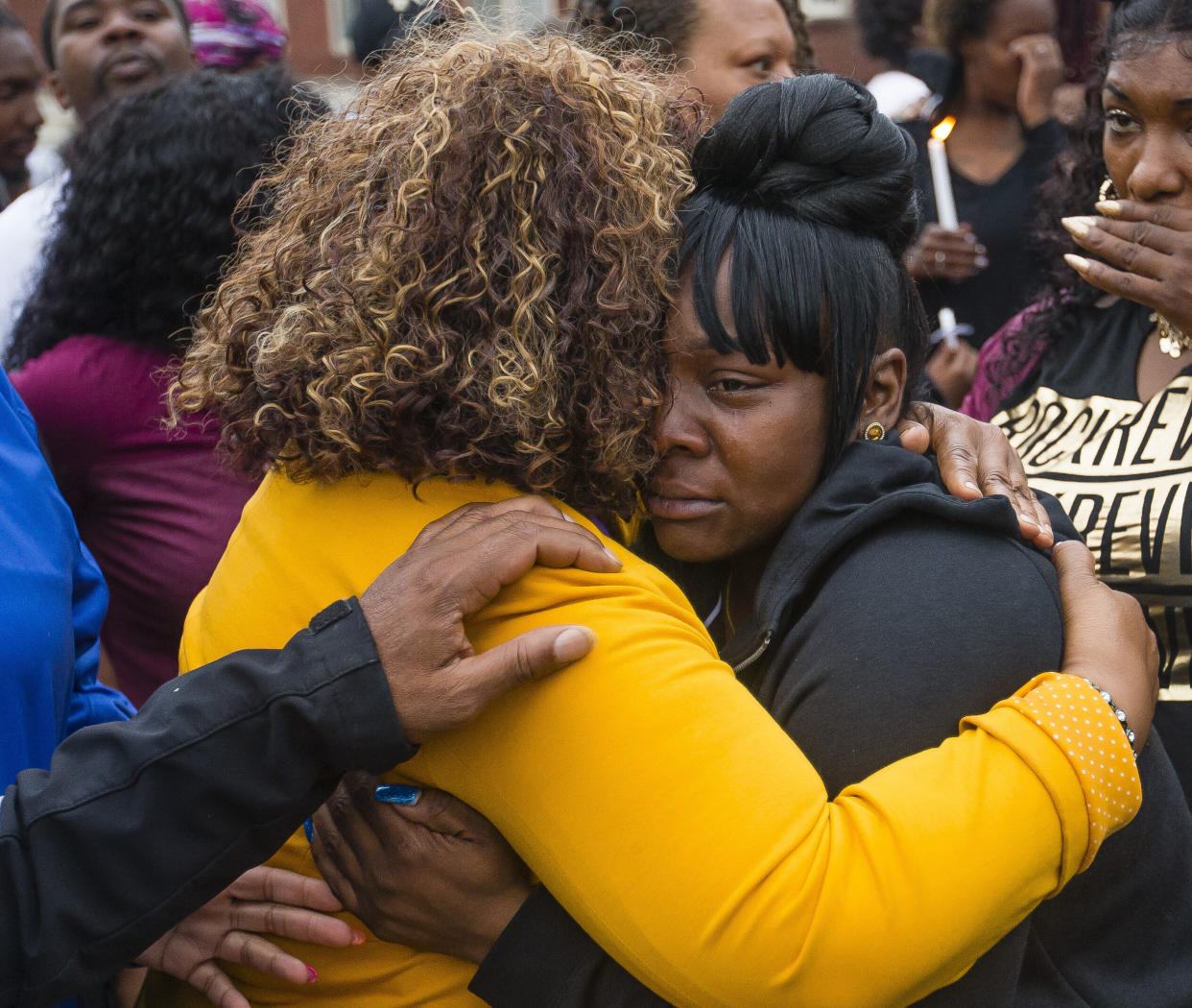 Family members embrace one another during a vigil for Eric Logan Monday, June 17, 2019, on Washington Street in South Bend, Ind. (Photo: ASSOCIATED PRESS)