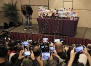 In this Tuesday, April 16, 2019, file photo, Hong Kong singer Andy Hui bows before a press conference about his affair in Hong Kong. Hong Kong's Apple Daily newspaper published video that purported to show Andy Hui being intimate in a taxi with another Hong actress, decades younger than him, Jacqueline Wong. (AP Photo/Vincent Yu, File)