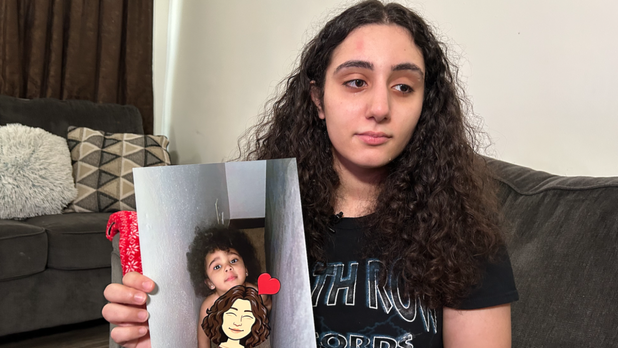 Sumiah Hamdan holds a photo of her daughter Nahlah Miah Barber who died when she accidentally swallowed a button battery March 19.