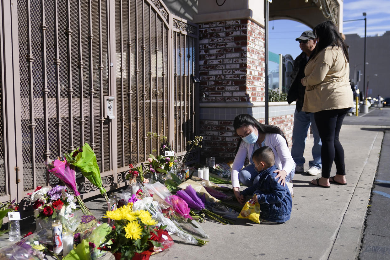 People pay their respects outside Star Ballroom Dance Studio.