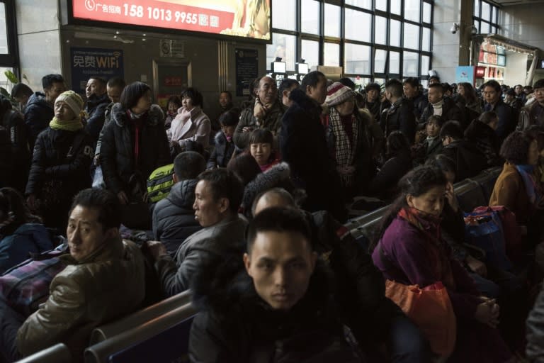 Travellers wait for a train at the West Railway Station in Beijing, as they depart the capital ahead of the Lunar New Year